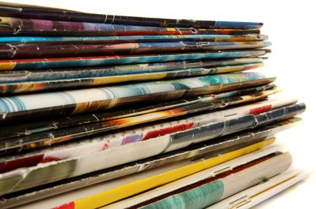 Stack of colorful magazines on light backgroundの写真素材