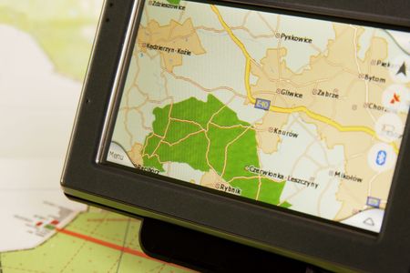 A GPS mobile (navigation device) and old traditional mapの写真素材