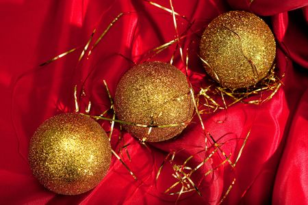 Christmas decoration. Gold Christmas balls on red backgroundの写真素材