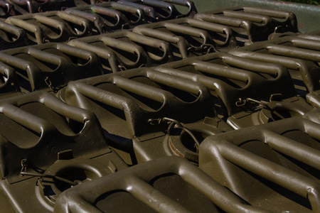 Military canisters background. Transprtatin theme. Oliwa green miliaris petrol canisters standing on the car trailerの写真素材