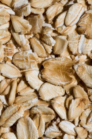 Close up. Dry, raw oatmeal (oat flakes, rolled oats) background or texture.の写真素材