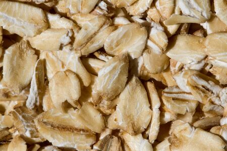 Close up. Dry, raw oatmeal (oat flakes, rolled oats) background or texture.の写真素材
