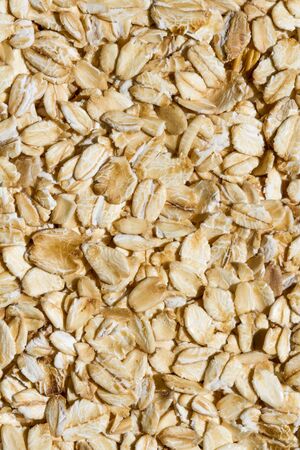Close up. Dry, raw oatmeal (oat flakes, rolled oats) background or texture.の写真素材