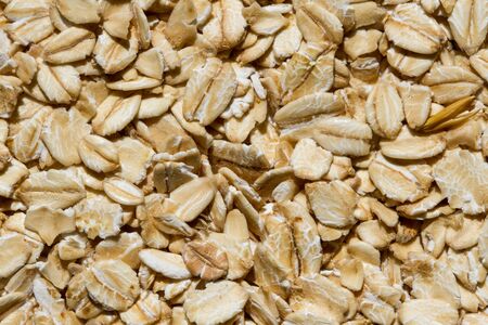 Close up. Dry, raw oatmeal (oat flakes, rolled oats) background or texture.の写真素材
