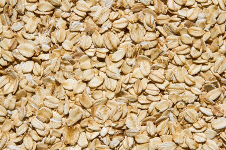 Close up. Dry, raw oatmeal (oat flakes, rolled oats) background or texture.の写真素材