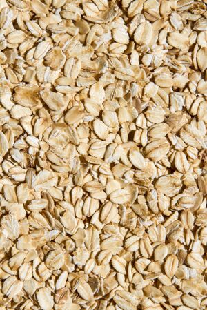 Close up. Dry, raw oatmeal (oat flakes, rolled oats) background or texture.の写真素材