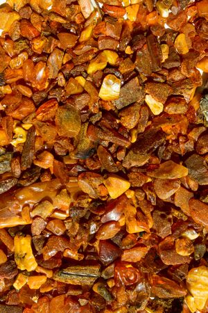 Close up. Background, texture. Orange, brown and yellow natural, raw amber stones found on the Polish cost of the Baltic Seaの写真素材