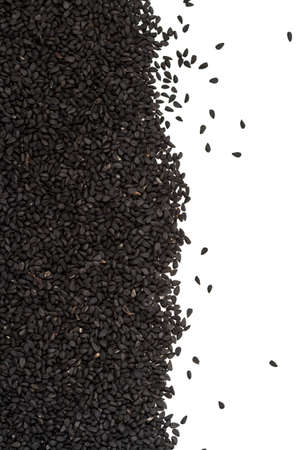 Close up. Dry, raw, black sesame seed frame on white background. Nigella sativa. A healthy ingredient.の写真素材