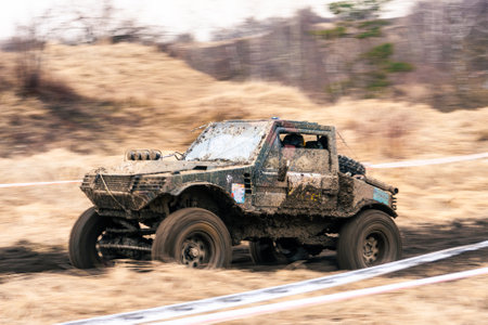 Dirty 4x4 vehicle starting in a off road competition. Dynamic shot of car on in the off road circuit...