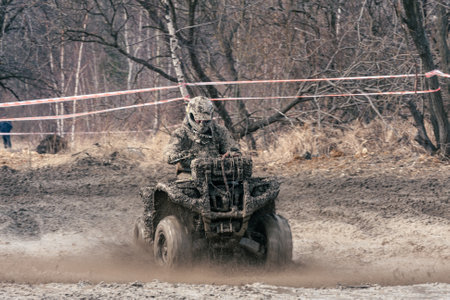 Quad competition. Dirty quad starting in a extreme competition. Dynamic shot of racer on quad motorbike in the raceの写真素材