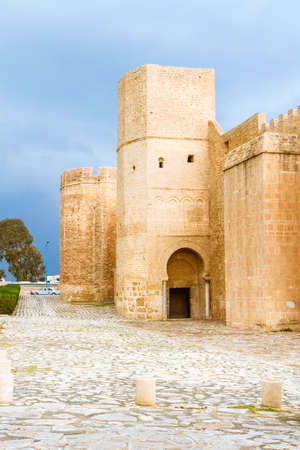 The huge, majestic walls and towers of Ribat fortress on a rainy day. Ribat is an architectural jewel of Monastir, Tunisiaの素材 [FY310179628164]