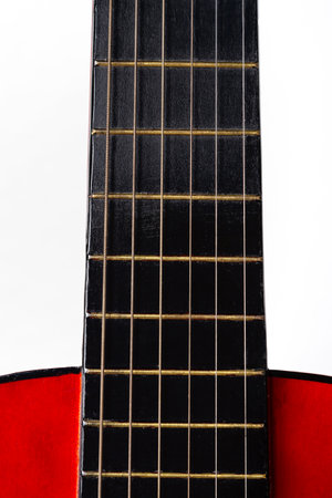 Close-up. A part of a red acoustic guitar on a white backgroundの写真素材