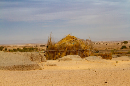 Tuareg encampment in the desert. Round huts built in a traditional way reed. South of Algeria, Illizi Province, Djanet, Algeria, Africaの写真素材