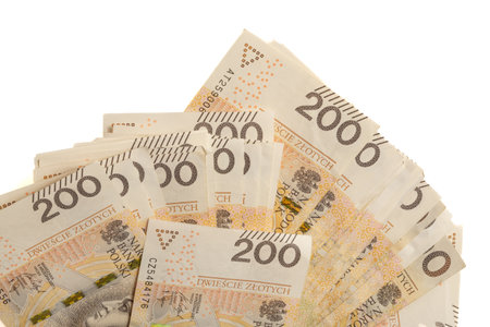 A large stack of Polish 200 zloty banknotes on a white background. Synonymous with wealth and abundance.の写真素材