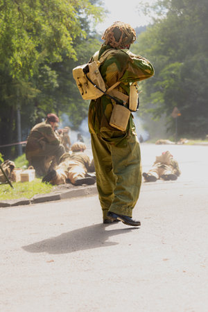 Reconstruction of battle from the Second World War. British paratrooper soldier during combat. View from the back. Porabka, Polandの写真素材