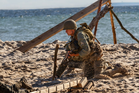 Historical reconstruction. An American infantry soldier from the World War II fighting on the beach.