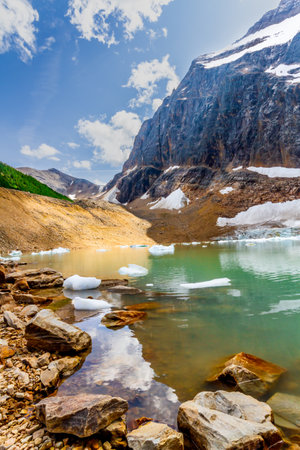 Landscape of Rocky Mountains. The small, turquoise Cavell pond and Mount Edith Cavell. Jasper National Park, Alberta, Canadaの写真素材