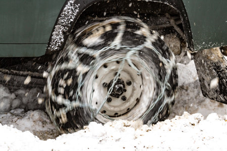 Close-up. The wheel of a car digging in deep snow. Capturing the movement and energy while driving...