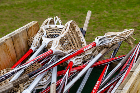 A stack of old lascrosse sticks in a wooden crate. Game gear. Canadaの写真素材