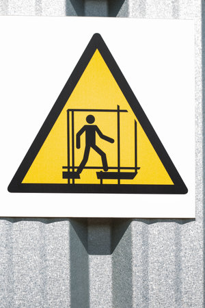 Safety sign on a construction site. Caution: work at heights. Polandの写真素材
