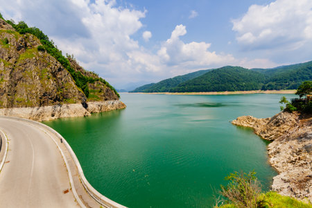 Vidraru Dam viewed from above. This concrete dam, built on the ArgeÈ River, creates the artificial Lake Vidraru. Fagaras Mountains, Transfagarasan roadの写真素材