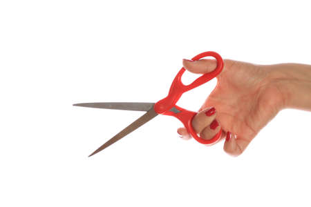 HAND HOLDING SCISSORS ON WHITE BACKGROUND
