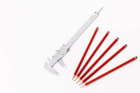 Analog Vernier Caliper with Group of Five Pencils Isolated on White Background