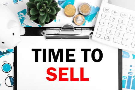 Text TIME TO SELL on clipboard. Piggy bank, coin, calculating machine on charts, documents and graphs background.の写真素材