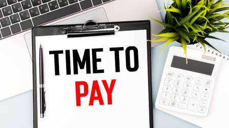 Text TIME TO SELL on clipboard. Piggy bank, coin, calculating machine on charts, documents and...