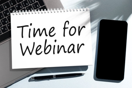 Text ONLINE WEBINAR on notebook, laptop, pen, cellphone.の写真素材