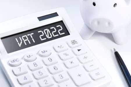 Text VAT 2022 - Value - Added Tax on calculator, laptop, chatrs, graphs. Business flat lay.の写真素材