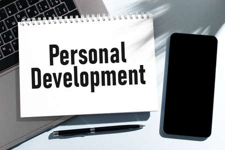 Text PERSONAL DEVELOPMENT on notebook, laptop, cellphone. Business concept. Flat lay.の写真素材