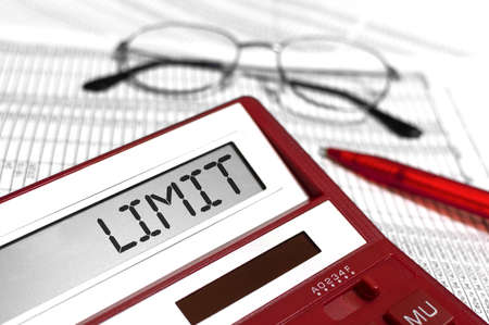 Word LIMIT on calculator. Glasses, pen and the calculator.の写真素材