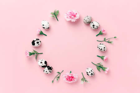 Spring pink herbs and flowers oval shaped composition on pink background. Blooming buds and fresh...