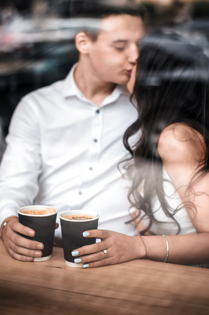 Young couple on a date drinking coffee in a cafe