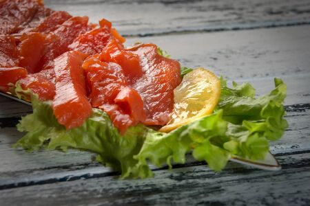 salted red fish with lemon and greensの写真素材