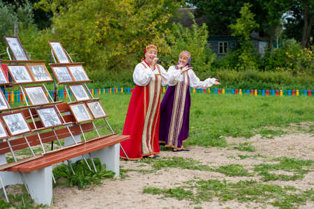 girls dance and sing in folk costumes at the festivalのeditorial素材