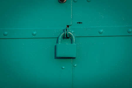 old rusty gates with padlocksの写真素材