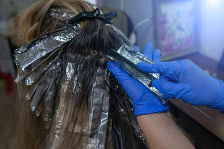 highlighting and coloring hair in a beauty salonの写真素材