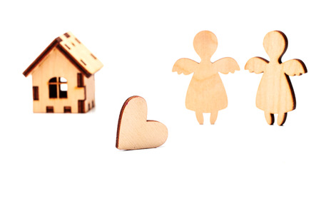 Wooden house, heart and angel on a white background.の写真素材