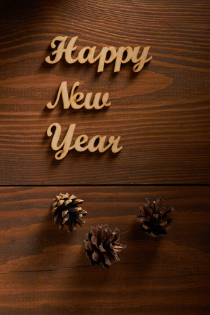 Happy New Year! - A phrase with wooden letters on a wooden background.の写真素材