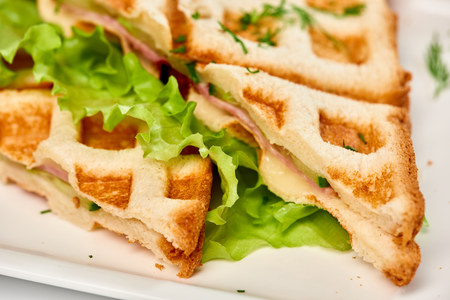 Waffle sandwich with ham and salad. Crispy sandwich with ham and salad. Breakfast.の写真素材