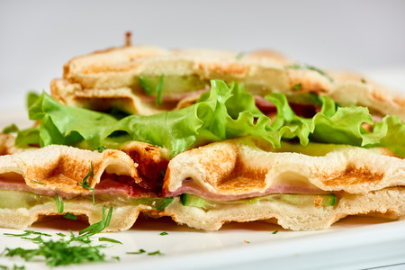 Waffle sandwich with ham and salad. Crispy sandwich with ham and salad. Breakfast.の写真素材