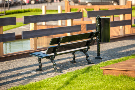 Outdoor photo of bench at park near riverの写真素材