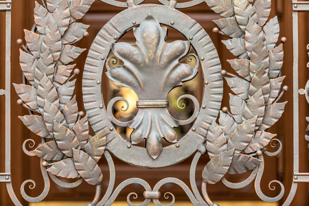 Closeup photo of forged metal decoration on gatesの写真素材