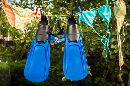 Conceptual photo of snorkeling equipment drying on clotheslineの写真素材