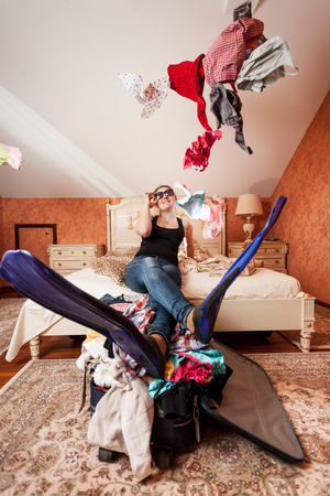 Beautiful woman getting ready for vacation on seaの写真素材