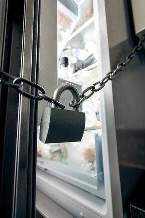 Closeup photo of lock hanging on refrigeratorの写真素材