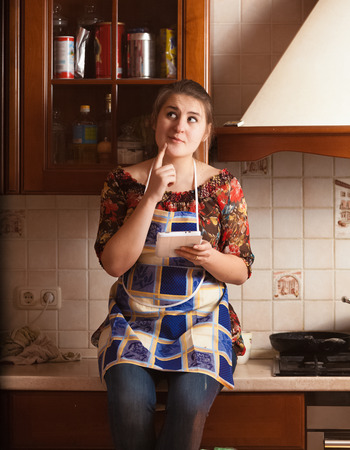 Closeup portrait of housewife remembering recipe of dishの写真素材