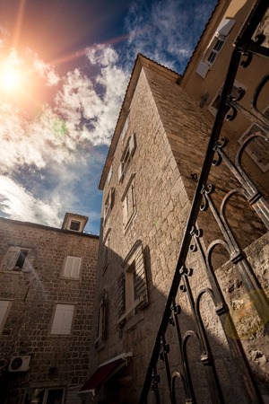 Photo from ground of old stone building against blue skyの写真素材